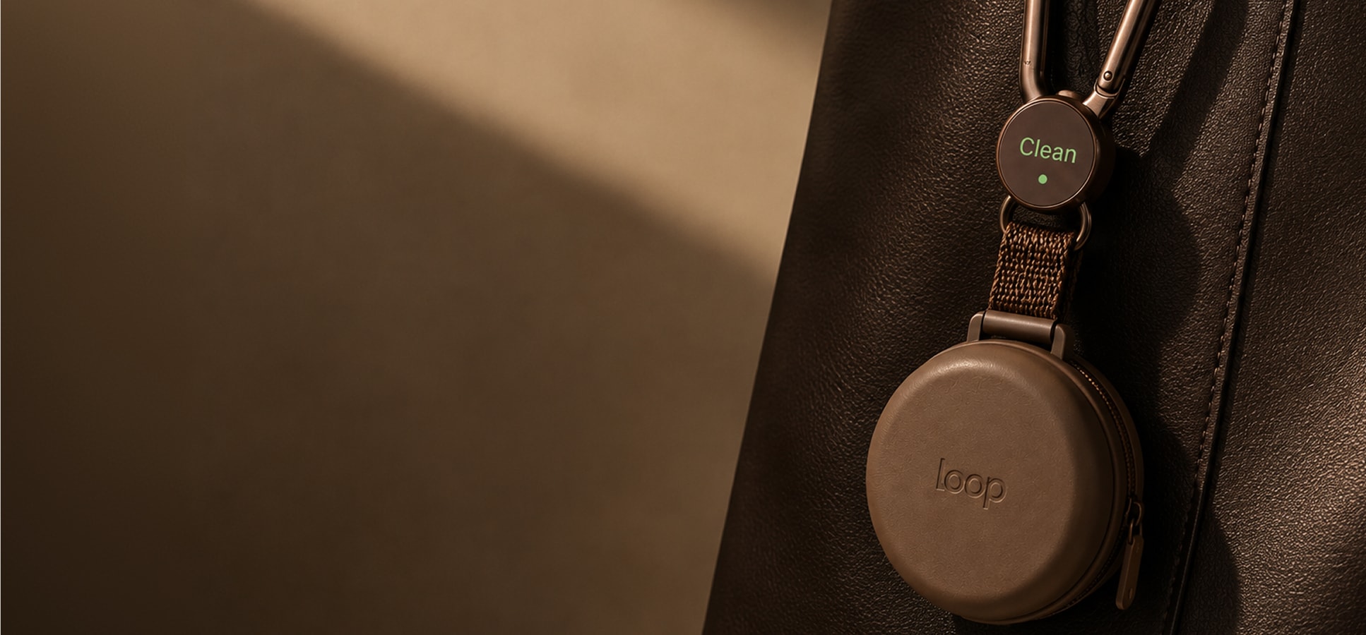 Loop cup clipped to the outside of a bag.
